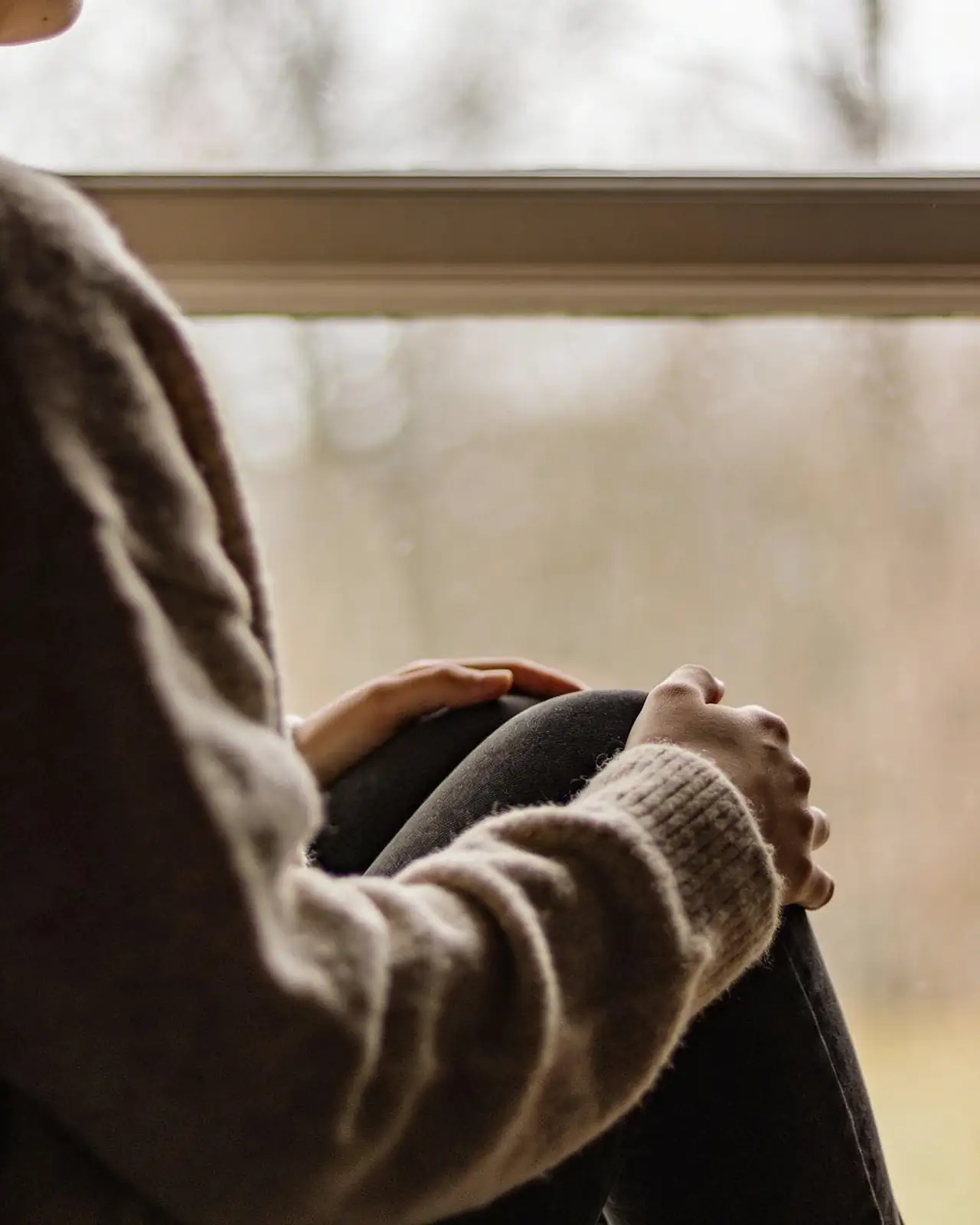 Hands holding a photograph in quiet remembrance